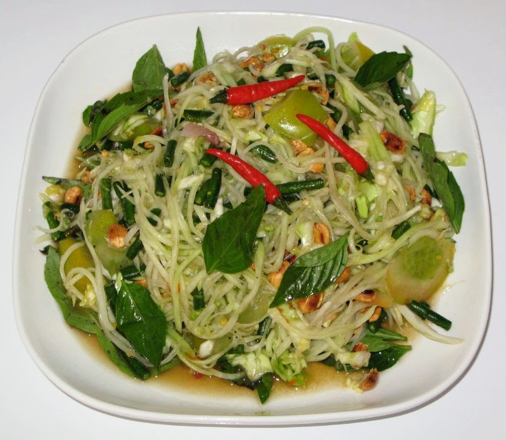 Green papaya salad with tomatoes, peanuts, lime, and chili on a platter, Natural window light, ivory linen, handmade ceramic, shallow depth of field, no text, no logo, no watermark, fine-dining magazine photograph. Green Papaya Salad