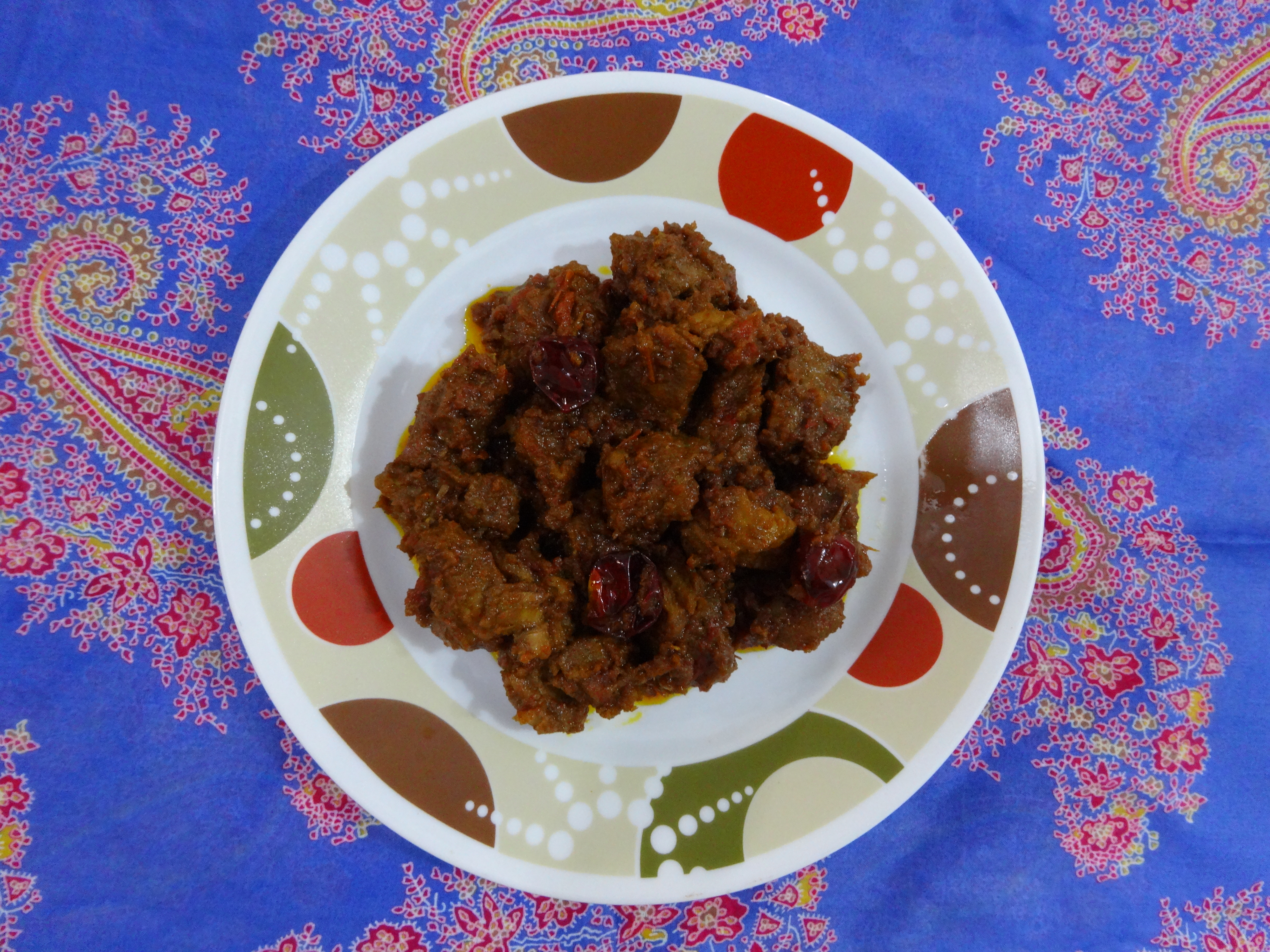 Photoreal photograph of the finished dish Beef rendang (rendang), the actual plate from Indonesia, handmade ceramic, natural window light, shallow depth of field, no text, no logo, no people, Natural window light, ivory linen, handmade ceramic, shallow depth of field, no text, no logo, no watermark, fine-dining magazine photograph. Beef rendang