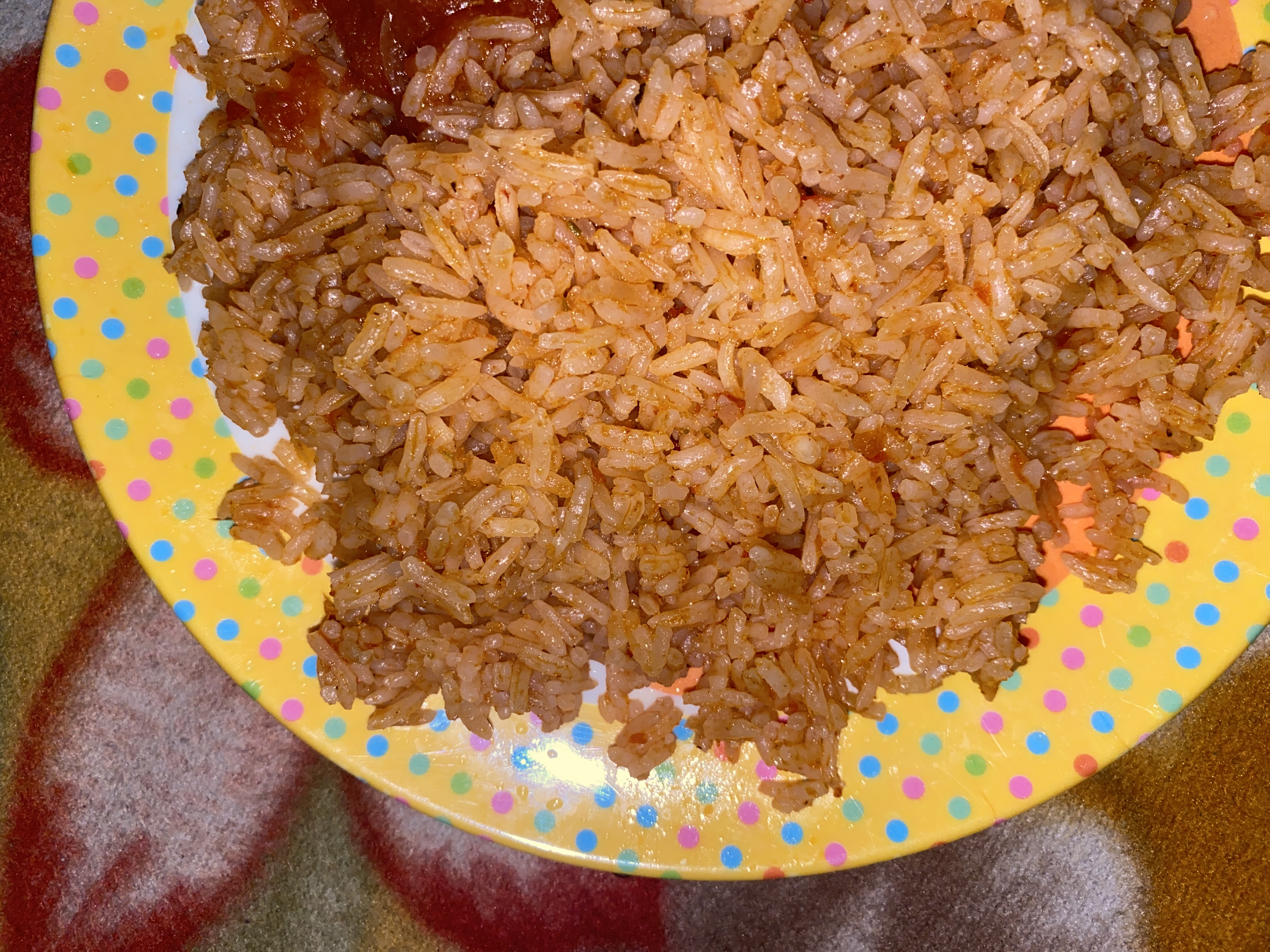 A pot of red jollof rice, grains separate, a few charred bits at the edge, Natural window light, ivory linen, handmade ceramic, shallow depth of field, no text, no logo, no watermark, fine-dining magazine photograph. Tomato Jollof