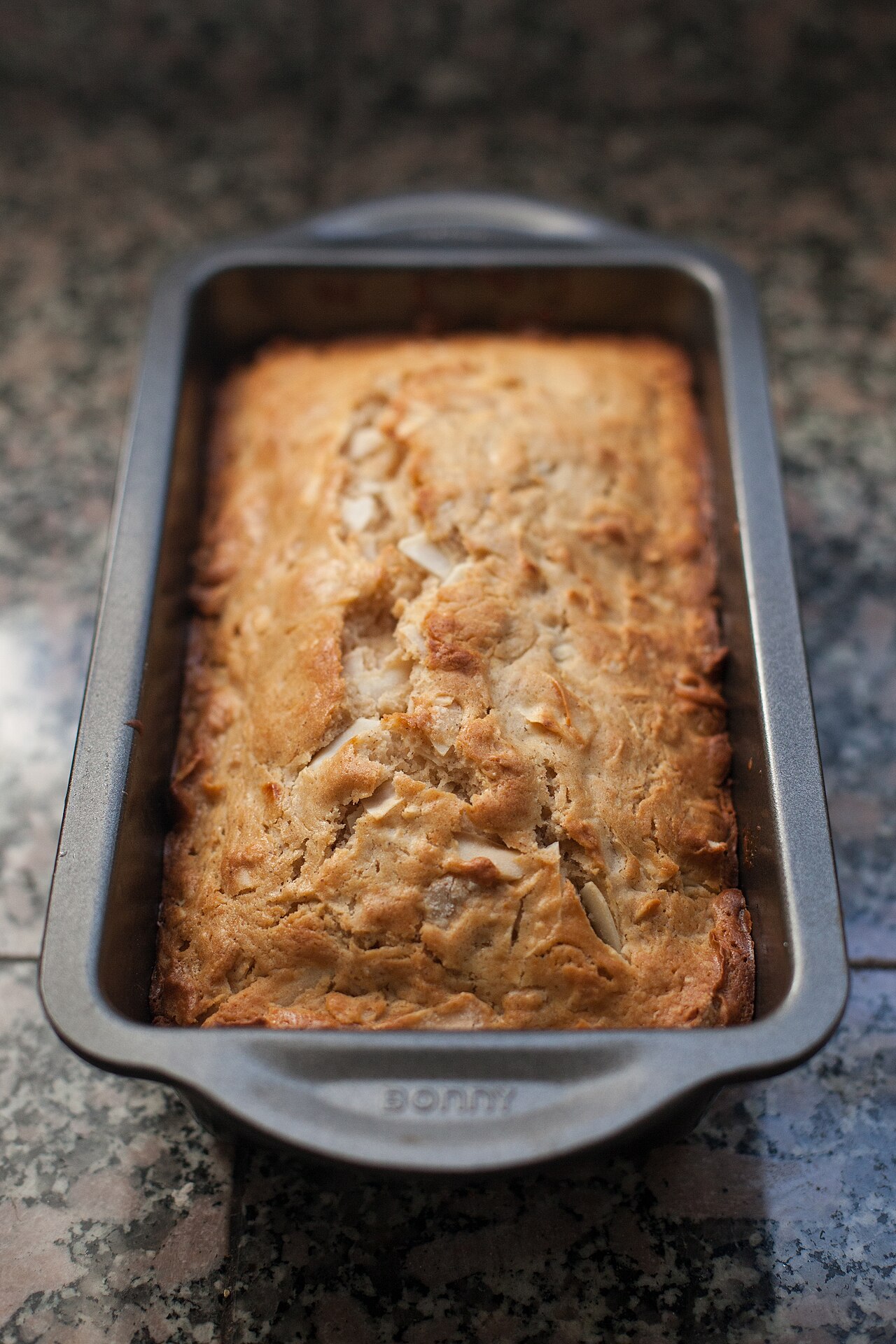 Photoreal photograph of the finished dish Coconut bread (bread), the actual plate from Tuvalu, handmade ceramic, natural window light, shallow depth of field, no text, no logo, no people, Natural window light, ivory linen, handmade ceramic, shallow depth of field, no text, no logo, no watermark, fine-dining magazine photograph. Coconut bread