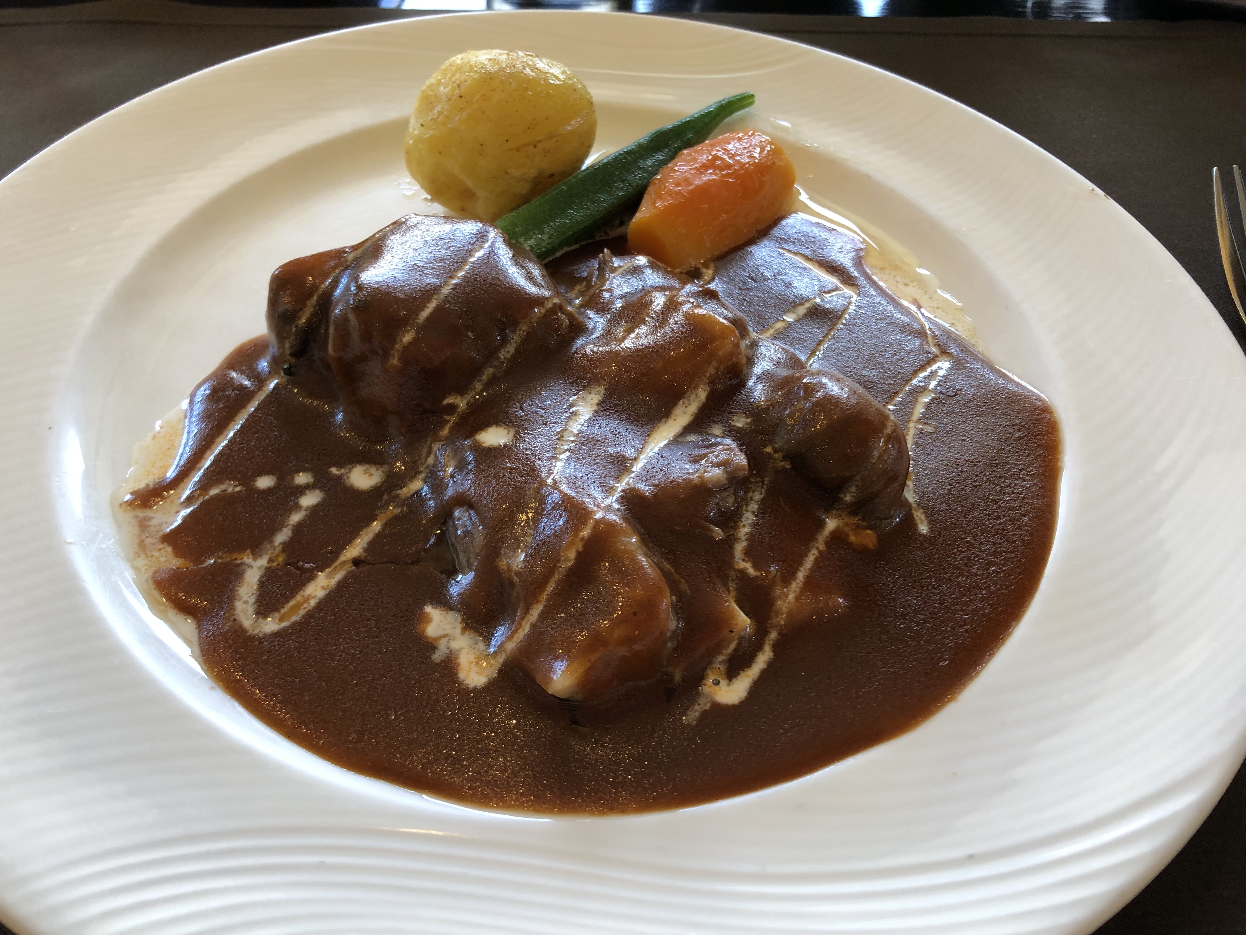 Photoreal photograph of the finished dish Beef stew (Nyama), the actual plate from Zimbabwe, handmade ceramic, natural window light, shallow depth of field, no text, no logo, no people, Natural window light, ivory linen, handmade ceramic, shallow depth of field, no text, no logo, no watermark, fine-dining magazine photograph. Beef stew